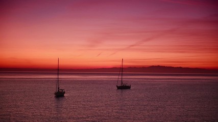 Wall Mural - Romantic pink scene with sea boats floating on the water, natural calm holiday background. HD quality