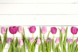 Fototapeta Tulipany - Pink tulips over shabby white wooden table