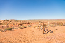 Old Wooden Fence In The Sandy Desert