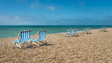 Deck chairs on a pebble beach