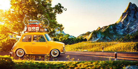 Cute little retro car goes by wonderful countryside road at sunset