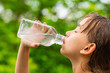 © Mikkel Bigandt - Girl drinking clean tap water from transparent glass bottle