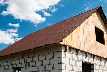 House of the blocks with roof of tiles and wooden loft under a b