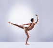 © Acronym - Athletic ballet dancer performing in a studio