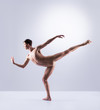 © Acronym - Athletic ballet dancer performing in a studio
