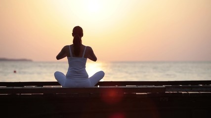 Wall Mural - Young woman doing yoga exercise