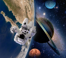 Wall Mural - Astronaut spaceman moon saturn planet spacewalk earth outer space walk galaxy. Elements of this image furnished by NASA.