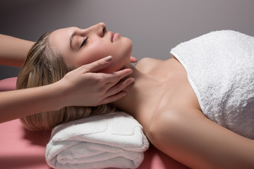 beautiful woman receiving facial massage