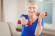 © WavebreakMediaMicro - Portrait of senior woman exercising with dumbbells