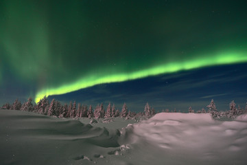 winter night landscape with forest, road, snow and northern light over the scene
