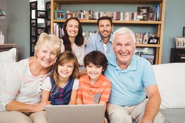 Poster - Portrait of smiling family with laptop