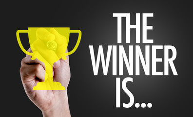 Wall Mural - hand writing the text: the winner is...