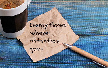 Inspiration motivation quotation Energy flows where attention goes and cup of coffee