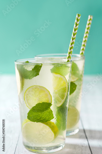 Plakat Summer drink. Fresh mojito with lime and mint. Blue background