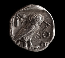 Ancient Greek Silver Coin With Owl On A Black Background