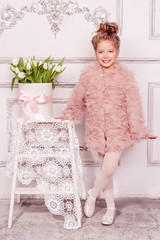 Wall Mural - Happy girl with box with white tulips. Kids fashion