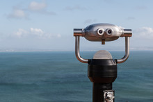 Sightseeing Binoculars Overlooking The Ocean From A High Vantage Point