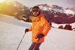 © ArtFamily - smiley skier in orange jacket