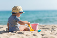 Cute Baby On Tropical Beach Playing Toys