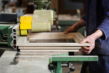 Carpenter's Hands Cutting Wooden Window Frame