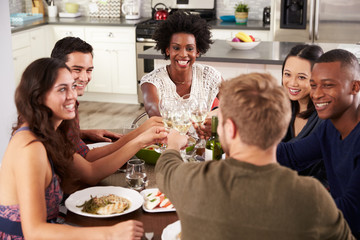 Wall Mural - Group Of Friends Making A Toast At Dinner Party