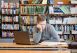 © Ermolaev Alexandr - sad and tired male student n library