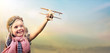 Leinwandbild Motiv Freedom To Dream - Joyful Child Playing With Airplane Against The Sky
