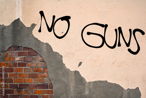 Fotografia, Obraz Handwritten graffiti No Guns sprayed on the wall, anarchist aesthetics