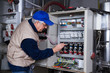 © franco lucato - electrician at work with an electric panel