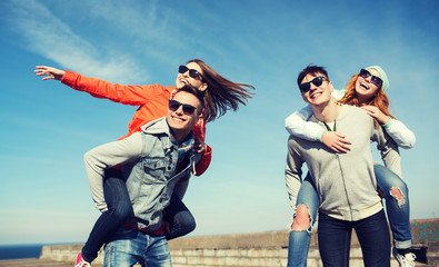 happy teenage friends having fun outdoors