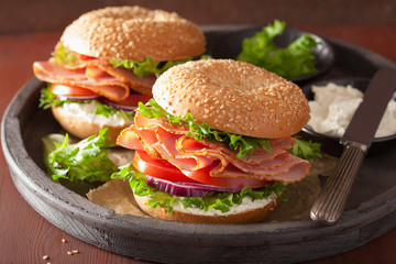 Wall Mural - ham sandwich on bagel with cream cheese tomato onion