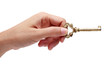  hand holding golden key isolated on white background.