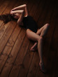 © maksimvostrikov - Seductive and passionate young charming lady in lingerie with dark beautiful long hair and sexy figure in perfect shape is lying stretched on the wooden floor and teasing us