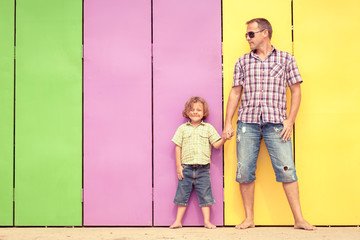 Wall Mural - Father and son relaxing near the house at the day time.