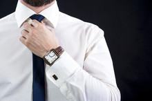 Elegant Bearded Man In White Shirt Tying Up His Necktie.