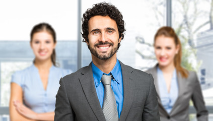 Poster - Portrait of a confident businessman in front of his team