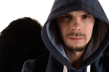 portrait of young man in gray hooded and black wing of right shoulder closeup