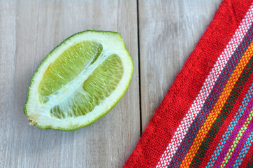 Wall Mural - Flat lay of ripe lime cut in half