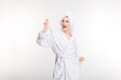 © Drobot Dean - Cheerful joyful young woman in bathrobe with towel on head