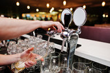 Fototapeta  - Close up of barman hand at beer tap