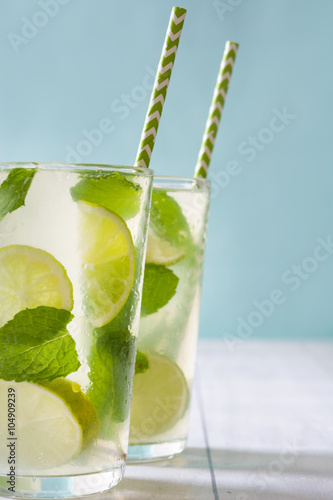 Plakat Summer drink. Fresh mojito with lime and mint. Blue background