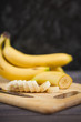 © polinabelphoto - sliced banana with a knife on wooden board