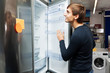 © caftor - young guy selecting domestic refrigerator