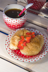 croissants and two cup of coffee on white wooden background