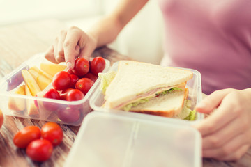 Wall Mural - close up of woman with food in plastic container