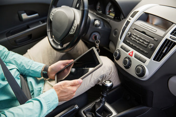 Canvas Print - close up of young man with tablet pc driving car