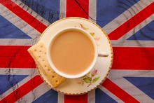 A Cup Of Tea In A Bone China Cup And Saucer On A Union Jack Flag