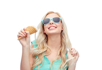 Wall Mural - happy young woman in sunglasses eating ice cream