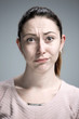 © master1305 - Woman is looking imploring over gray background