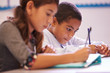 © Monkey Business - Two elementary school pupils working at desk during a lesson